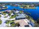 Stunning aerial view of a waterfront home with a screened-in pool, lush landscaping, and serene water views at 17115 Barcrest Ln, Punta Gorda, FL 33955