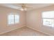 Neutral bedroom with tile floors, a ceiling fan and bright windows at 17115 Barcrest Ln, Punta Gorda, FL 33955