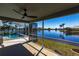 Covered lanai boasting a ceiling fan and scenic views of the lake and pool at 17115 Barcrest Ln, Punta Gorda, FL 33955