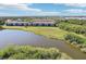 Waterfront condo buildings with views of a tranquil lake and green surroundings at 175 Kings Hwy # 717, Punta Gorda, FL 33983
