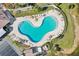 Kidney bean pool shape in resort-style community surrounded by mature landscaping and seating at 175 Kings Hwy # 717, Punta Gorda, FL 33983