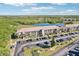 Condominium complex overlooking a pond, with lush landscaping and convenient parking at 175 Kings Hwy # 717, Punta Gorda, FL 33983
