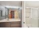 Bathroom featuring a large mirror with vanity lights and a glass-enclosed shower at 175 Kings Hwy # 717, Punta Gorda, FL 33983