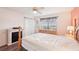 Bedroom with wood floors, fireplace, natural light and ceiling fan at 175 Kings Hwy # 717, Punta Gorda, FL 33983