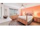 Bedroom with wood floors, natural light, ceiling fan and decorative headboard at 175 Kings Hwy # 717, Punta Gorda, FL 33983