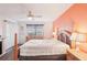 Bedroom with wood floors, decorative headboard, fireplace, ceiling fan and natural light at 175 Kings Hwy # 717, Punta Gorda, FL 33983