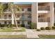 Attractive condo building featuring a lush, green landscaped yard and a well-maintained walkway leading to the entrance at 175 Kings Hwy # 717, Punta Gorda, FL 33983
