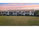 Exterior of the condo building on a sprawling lawn with views of palm trees and the sunset at 175 Kings Hwy # 717, Punta Gorda, FL 33983