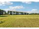 Wide shot of condo building with a manicured lawn and mature landscaping at 175 Kings Hwy # 717, Punta Gorda, FL 33983