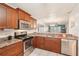 Kitchen featuring granite countertops, stainless steel appliances, and a view of the living area at 175 Kings Hwy # 717, Punta Gorda, FL 33983