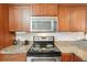 Close-up of a kitchen with stainless steel appliances and granite countertops at 175 Kings Hwy # 717, Punta Gorda, FL 33983