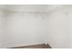Spacious walk-in closet featuring white wire shelving and wood-look flooring at 175 Kings Hwy # 717, Punta Gorda, FL 33983