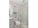 Bright bathroom featuring a glass shower, white cabinets and toilet with tiled floors at 196 The Corso # 196, Venice, FL 34285