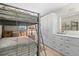 Comfortable bedroom featuring a bunk bed, tiled floors, and ample storage at 196 The Corso # 196, Venice, FL 34285