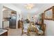 Charming dining area with tile floors, decorative ceiling fan and open floor plan at 196 The Corso # 196, Venice, FL 34285