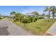 Inviting neighborhood featuring lush landscaping and mature palm trees at 196 The Corso # 196, Venice, FL 34285