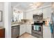 Updated kitchen boasts stainless steel appliances, granite counters, and white cabinets at 196 The Corso # 196, Venice, FL 34285