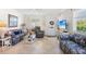 Cozy living room with neutral colors and tile floors that flood the home with natural light at 196 The Corso # 196, Venice, FL 34285