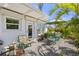 Relaxing outdoor patio with dining area and cushioned seating, surrounded by tropical foliage at 196 The Corso # 196, Venice, FL 34285