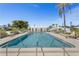 Community pool featuring crystal blue water, lounge chairs, and palm trees at 196 The Corso # 196, Venice, FL 34285