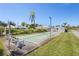 Community shuffleboard court featuring benches and palm trees on a sunny day at 196 The Corso # 196, Venice, FL 34285