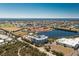 Aerial view of a condo building near a lake surrounded by lush greenery, golf course, and residential homes at 2001 Bal Harbor Blvd # 2202, Punta Gorda, FL 33950