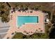 Overhead aerial of a rectangular outdoor community pool with lounge chairs, patio tables, and lush landscaping at 2001 Bal Harbor Blvd # 2202, Punta Gorda, FL 33950