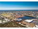 Aerial view of a condo building near a lake surrounded by lush greenery, golf course, and residential homes at 2001 Bal Harbor Blvd # 2202, Punta Gorda, FL 33950