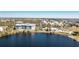 Aerial view of a modern condo building near a lake with lush landscaping, a pool, and beautiful surrounding neighborhood at 2001 Bal Harbor Blvd # 2202, Punta Gorda, FL 33950