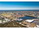 Aerial view of a condo building near a lake surrounded by lush greenery, golf course, and residential homes at 2001 Bal Harbor Blvd # 2202, Punta Gorda, FL 33950