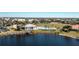 Aerial view showcasing a neighborhood pool and clubhouse near the lake with a private dock and manicured landscaping at 2001 Bal Harbor Blvd # 2202, Punta Gorda, FL 33950