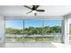 Screened-in balcony with a ceiling fan overlooking mature trees at 2001 Bal Harbor Blvd # 2202, Punta Gorda, FL 33950