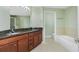 Bathroom with double sink vanity, tub, and glass enclosed shower at 2001 Bal Harbor Blvd # 2202, Punta Gorda, FL 33950