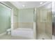 Bright bathroom featuring a tub and separate glass-enclosed shower at 2001 Bal Harbor Blvd # 2202, Punta Gorda, FL 33950