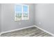 This bedroom features wood-look floors and a window offering natural light and views at 2001 Bal Harbor Blvd # 2202, Punta Gorda, FL 33950
