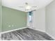 Bedroom with hardwood floors, ceiling fan, and a window with curtains at 2001 Bal Harbor Blvd # 2202, Punta Gorda, FL 33950