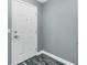 Condominium front door with gray wood look floors and gray paint at 2001 Bal Harbor Blvd # 2202, Punta Gorda, FL 33950