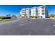 Attractive multi-story blue condo building with palm trees and well-maintained landscaping at 2001 Bal Harbor Blvd # 2202, Punta Gorda, FL 33950