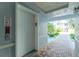 Condominium hallway with access to elevator, outdoor seating, and lush landscaping at 2001 Bal Harbor Blvd # 2202, Punta Gorda, FL 33950