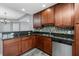 Well-lit kitchen features wooden cabinets, stainless steel appliances, granite countertops, and mosaic backsplash at 2001 Bal Harbor Blvd # 2202, Punta Gorda, FL 33950