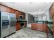 Well-lit kitchen features wooden cabinets, stainless steel appliances, granite countertops, and mosaic backsplash at 2001 Bal Harbor Blvd # 2202, Punta Gorda, FL 33950