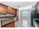 Charming kitchen featuring wood cabinets, granite countertops and stainless steel appliances at 2001 Bal Harbor Blvd # 2202, Punta Gorda, FL 33950