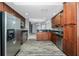 Well-lit kitchen features wooden cabinets, stainless steel appliances, granite countertops, and mosaic backsplash at 2001 Bal Harbor Blvd # 2202, Punta Gorda, FL 33950