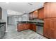 Well-lit kitchen features wooden cabinets, stainless steel appliances, granite countertops, and mosaic backsplash at 2001 Bal Harbor Blvd # 2202, Punta Gorda, FL 33950
