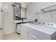Laundry room featuring washer, dryer, hot water heater, utility sink and shelving at 2001 Bal Harbor Blvd # 2202, Punta Gorda, FL 33950