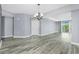 Spacious living room featuring gray wood look floors and sliding glass door to the balcony at 2001 Bal Harbor Blvd # 2202, Punta Gorda, FL 33950