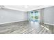 Bright living room with hardwood floors, ceiling fan, and sliding glass doors to the outside at 2001 Bal Harbor Blvd # 2202, Punta Gorda, FL 33950