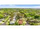 Neighborhood aerial view shows the tree lined streets and the screened pool at 2027 59Th N St, Clearwater, FL 33760