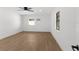 Bright bedroom featuring wood-look flooring, ceiling fan, and windows for natural light at 2027 59Th N St, Clearwater, FL 33760