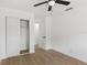 Bedroom showing wood-look flooring, ceiling fan and sliding door closet provides convenience at 2027 59Th N St, Clearwater, FL 33760